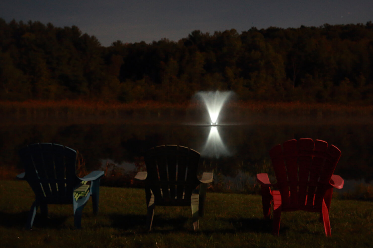 One of Otterbine Gemini Aerating Fountains lit up at night